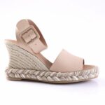 Nude wedge espadrille sandal with braided jute sole and wide ankle strap with a square buckle.