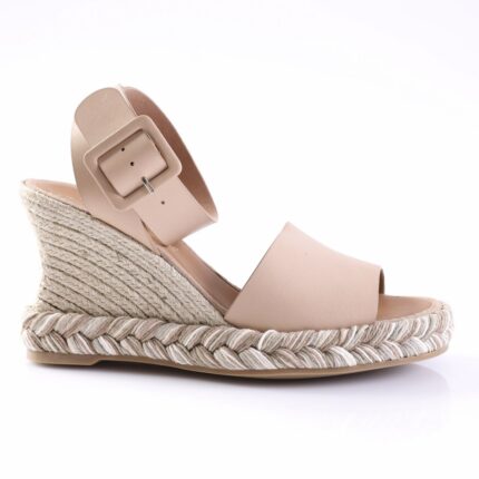 Nude wedge espadrille sandal with braided jute sole and wide ankle strap with a square buckle.