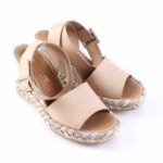Beige open-toe espadrille wedge sandals with braided rope sole and ankle buckle.