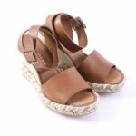 Brown leather espadrille sandals with ankle straps and braided rope sole.