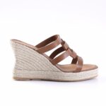 Brown leather wedge sandal with a woven jute platform and multiple straps across the top, open toe design.