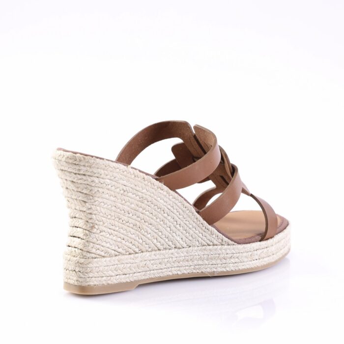 Brown strappy espadrille wedge sandal with a braided jute heel, shown from the side on a white background
