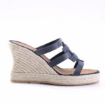 Navy blue strappy wedge espadrille sandal with a braided jute sole on a light background.