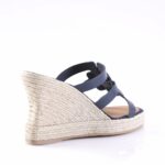 Navy blue espadrille wedge sandal with braided jute heel and ankle straps, shown from the side.