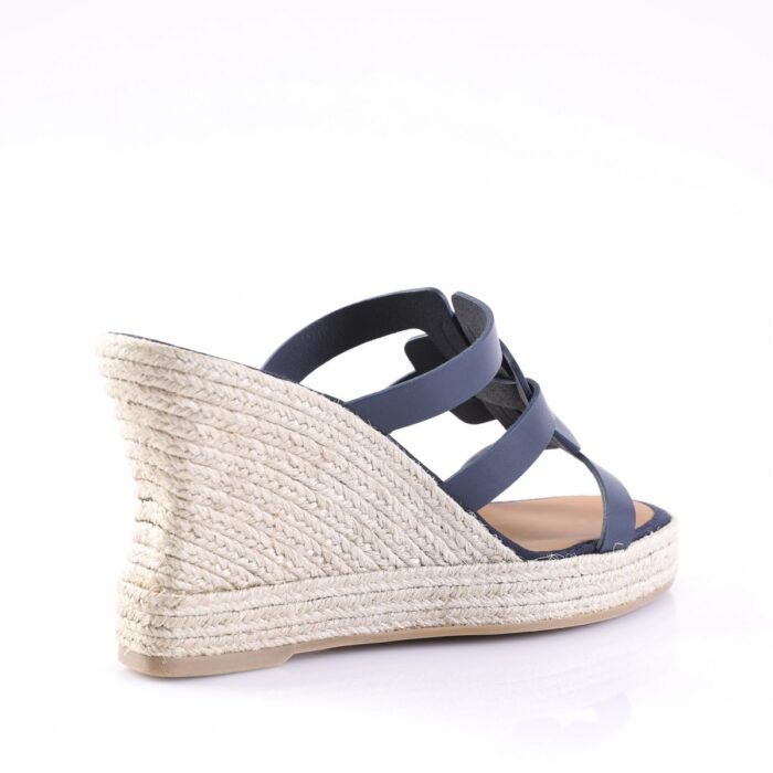 Navy blue espadrille wedge sandal with braided jute heel and ankle straps, shown from the side.