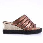 Rose gold strappy wedge sandal with braided rope heel and black platform sole in a side view