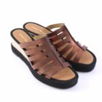 Brown leather wedge sandals with multiple straps and a black woven sole for a casual look.