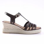 Black strappy wedge sandal with a braided jute platform and ankle buckle detail.