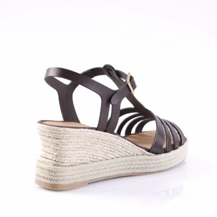 Black strappy wedge sandal with a braided jute espadrille sole and a small gold buckle at the ankle.