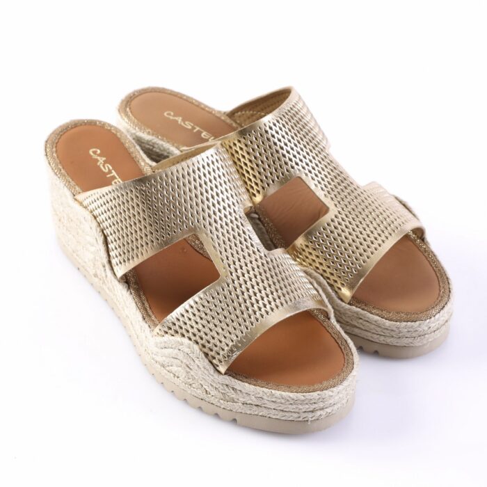 Gold metallic wedge sandals with perforated straps and a woven espadrille-style sole on a white background, viewed from a three-quarter angle.