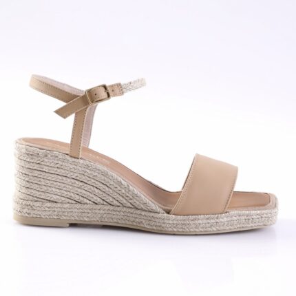 Beige leather wedge sandal with a buckle ankle strap and braided espadrille sole.