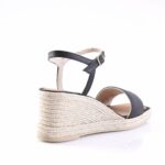 Navy blue espadrille wedge sandal with ankle strap and woven rope heel, viewed from the back-right side.