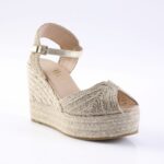 Gold espadrille wedge sandal with braided jute platform and ankle strap.