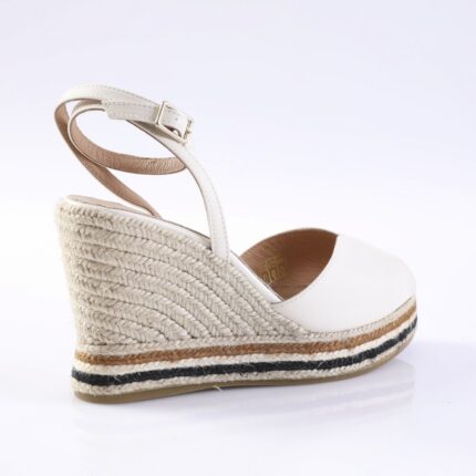 White wedge espadrille sandal with an ankle strap and braided jute platform, on a white background
