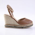 Brown leather wedge sandal with ankle strap and rope-wrapped heel, featuring a striped espadrille sole in tan, beige, and black.