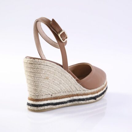 Tan leather wedge sandal with an adjustable ankle strap and braided jute platform (espadrille).