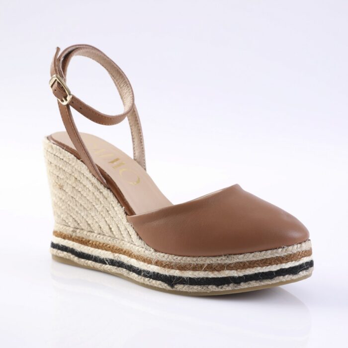 Brown leather espadrille wedge sandal with ankle strap and rope-wrapped sole, shown from a side angle.