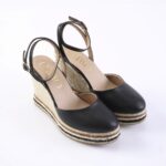 Black leather wedge espadrille sandals with ankle straps and braided rope sole for women.