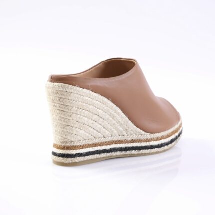 Espadrille wedge sandal with tan leather upper and braided jute heel, seen from the back on a white backdrop.
