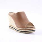 Brown open-toe wedge sandal with a braided jute sole and stacked espadrille layers featuring natural and black stripes.