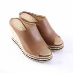 Brown leather wedge espadrilles with peep toe and woven rope sole on a white background.