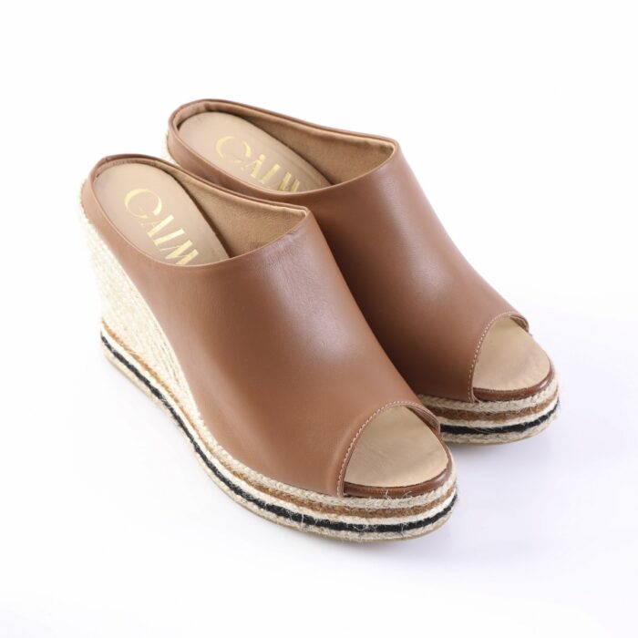 Brown leather wedge espadrilles with peep toe and woven rope sole on a white background.