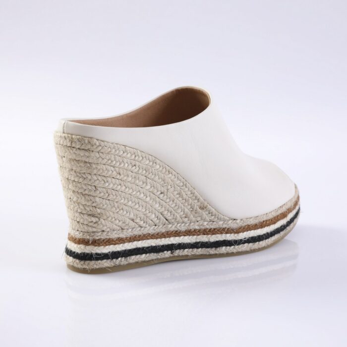 White leather espadrille wedge sandal with a braided jute heel and a striped sole edge along the bottom.