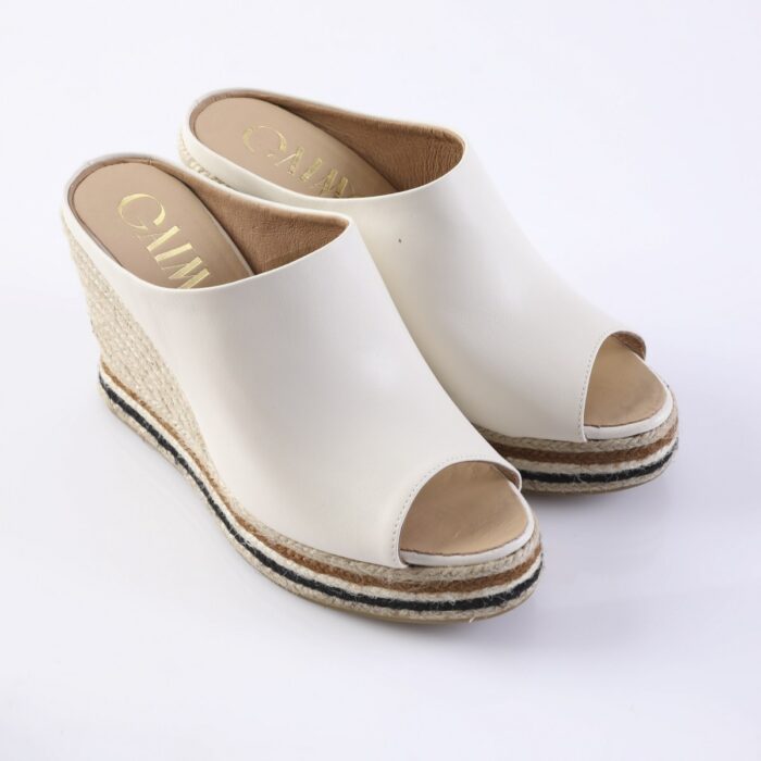 White open-toe espadrille wedges with a braided rope sole and natural jute, photographed on a white background