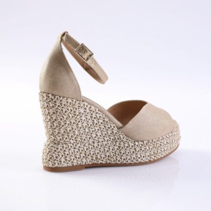 Beige wedge espadrille sandal with ankle strap and woven jute sole on a white background