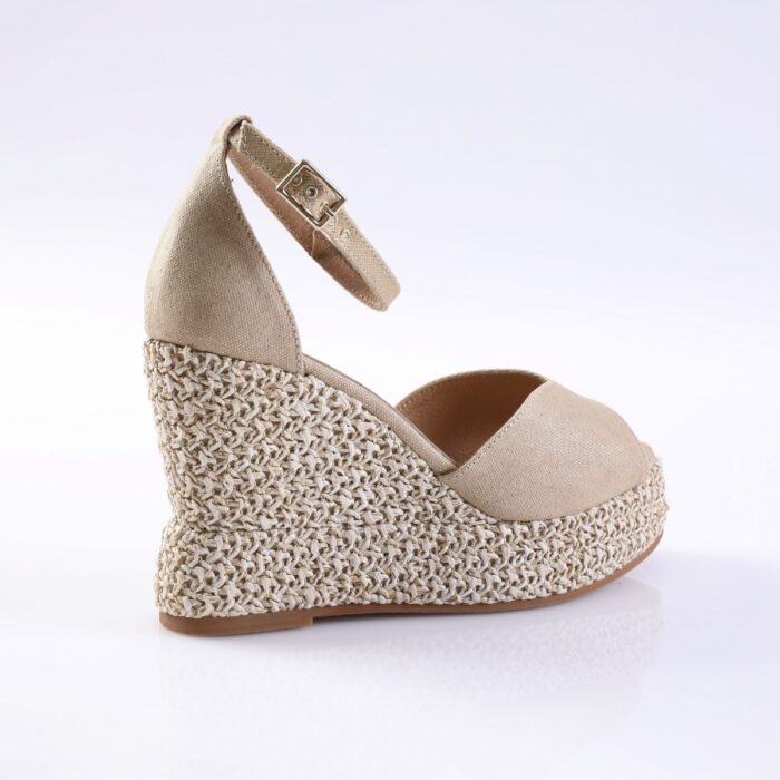 Beige wedge espadrille sandal with ankle strap and woven jute sole on a white background