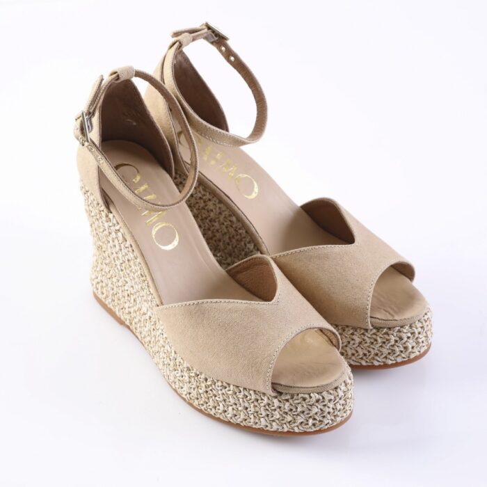 Beige open-toe wedge espadrille sandals with woven jute platform and ankle strap.