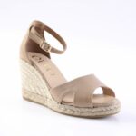 Beige peep-toe wedge sandal with ankle strap and braided jute heel on a white background.