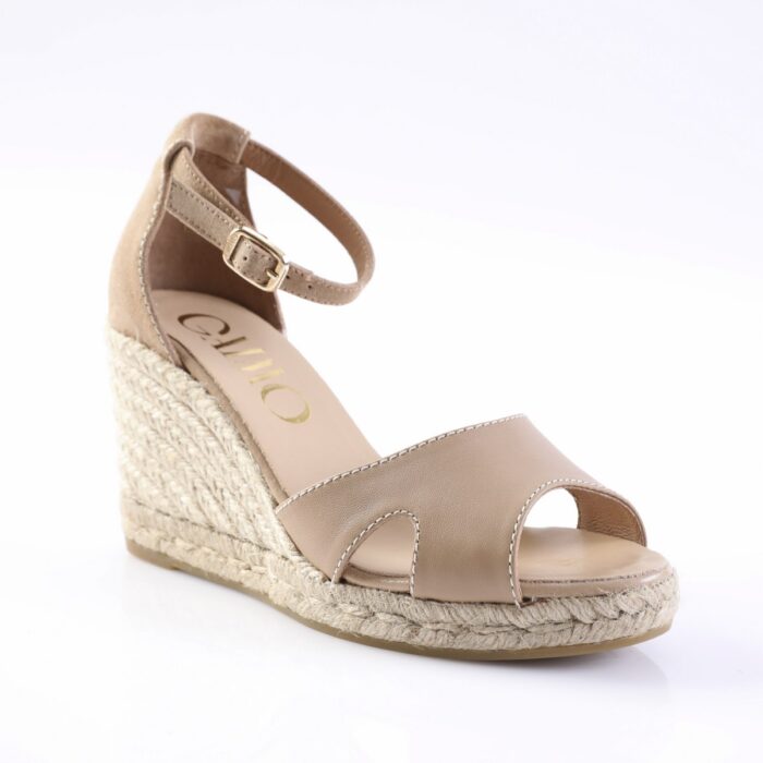 Beige peep-toe wedge sandal with ankle strap and braided jute heel on a white background.