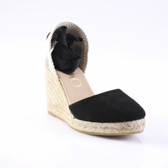 Black closed-toe espadrille wedge with a natural rope sole and a fabric bow at the heel area, shown from a front-side angle