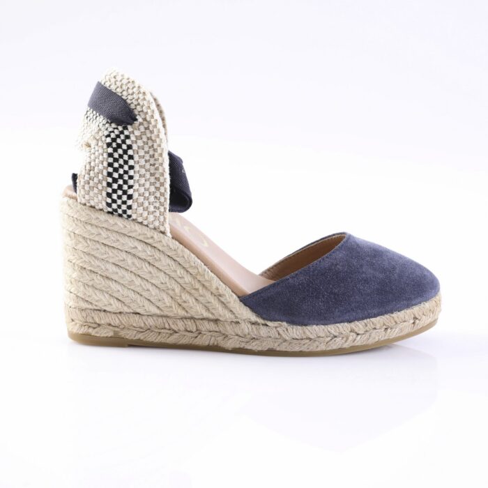 Navy blue suede espadrille wedge sandal with a braided rope sole and woven back panel.