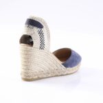 Navy blue suede espadrille wedge sandal with a braided rope heel and woven back strap. Alternative: Wedge sandal with navy toe, braided rope sole, and checkered back strap.