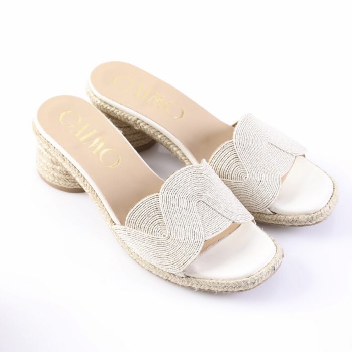 Beige wedge espadrille sandals with braided jute sole and decorative wavy strap across the top, open-toe design
