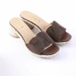 Brown open-toe espadrille wedges with braided rope sole and dark brown woven upper, on a white background