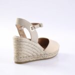 Beige wedge espadrille sandal with braided jute platform and ankle strap with buckle (side view).