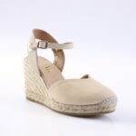 Beige wedge espadrille sandal with an adjustable ankle strap and braided rope sole.