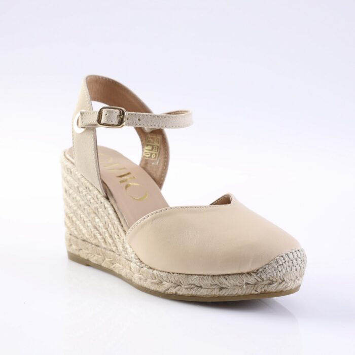 Beige wedge espadrille sandal with an adjustable ankle strap and braided rope sole.