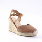 Brown leather espadrille wedge sandal with an adjustable ankle strap and braided jute sole on a white background.