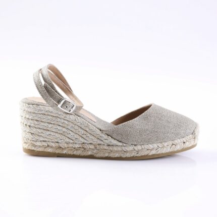 Glittery silver espadrille wedge sandal with an ankle strap and braided rope heel surface. - Informative product image