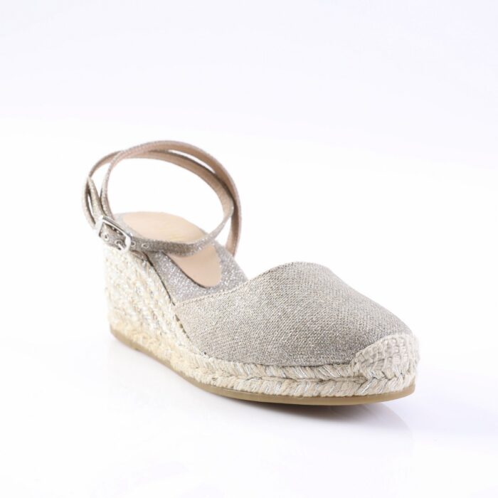 Silver glitter espadrille wedge sandal with ankle strap and woven jute sole on a white background.