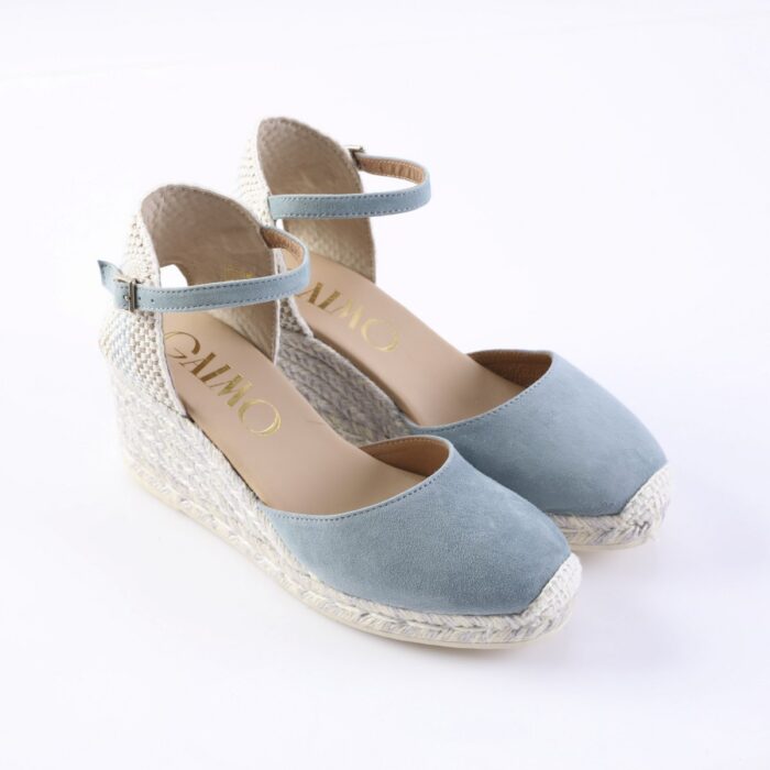 Pastel blue suede wedge espadrilles with ankle straps and woven jute soles, on a white background (brand visible inside).