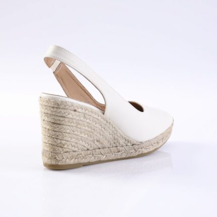 White wedge espadrille sandal with an ankle strap and natural braided jute sole.