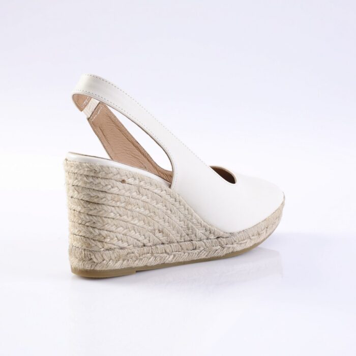 White wedge espadrille sandal with an ankle strap and natural braided jute sole.