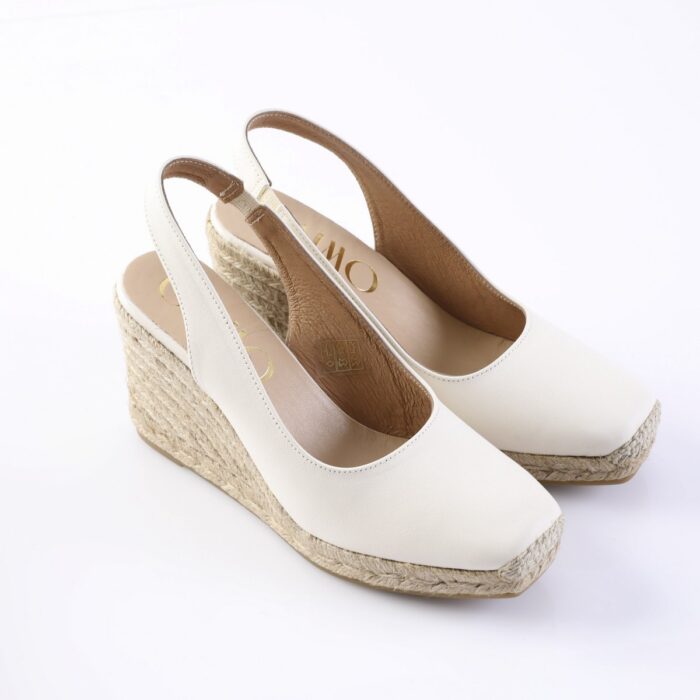 White slingback wedge espadrille sandals with braided jute platform and open toe, shown from a side angle on a white background.