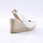 Silver metallic wedge espadrille with ankle strap and braided jute sole, side view