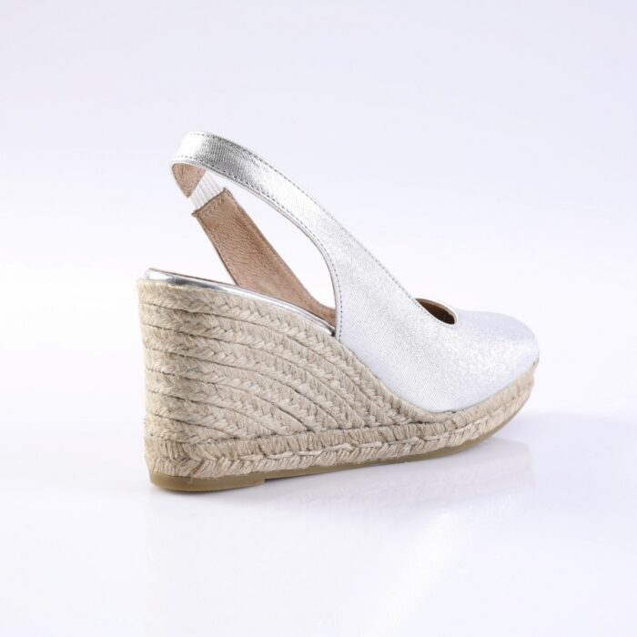 Silver metallic wedge espadrille with ankle strap and braided jute sole, side view